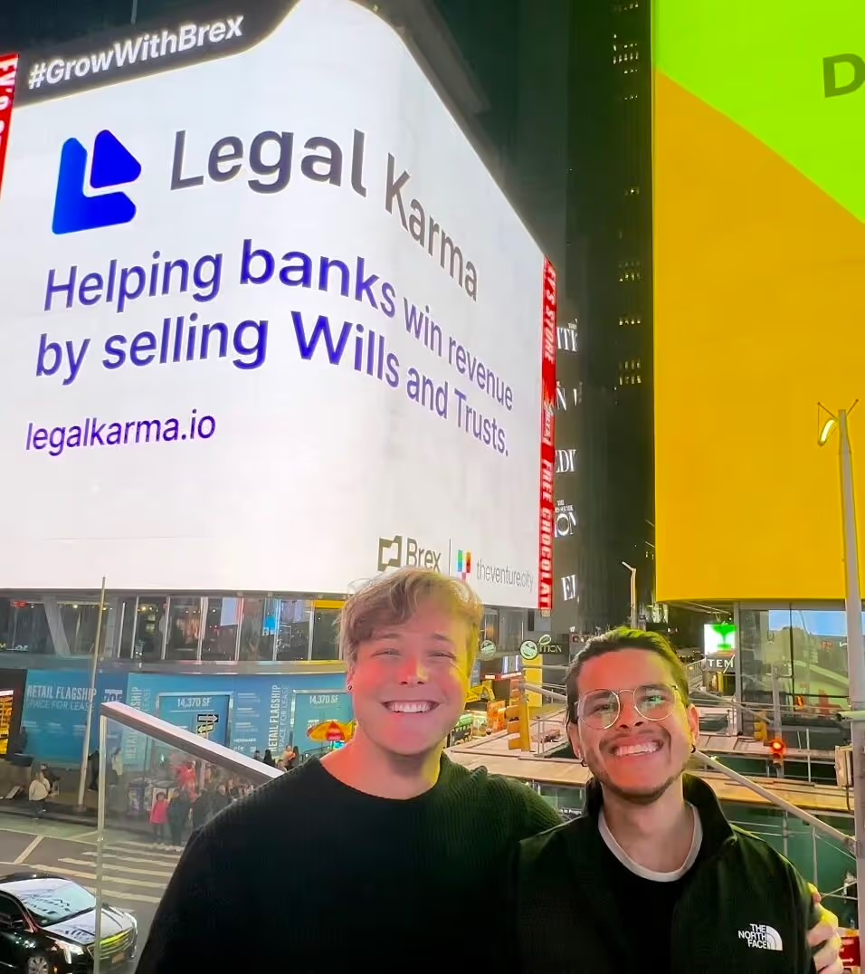 Kory and co-founder Mauricio Cano in Times Square under the Legal Karma billboard